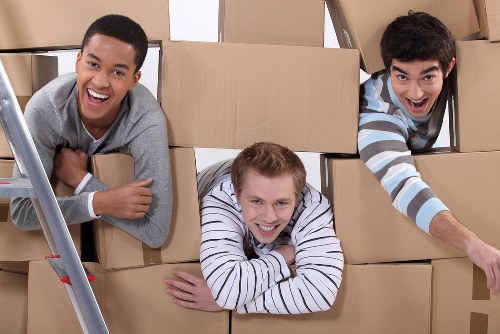 Packed moving boxes and furniture ready for collection in Brent