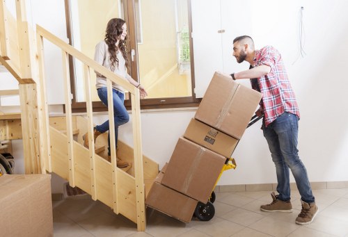 Local movers handling furniture in a Brent residential street