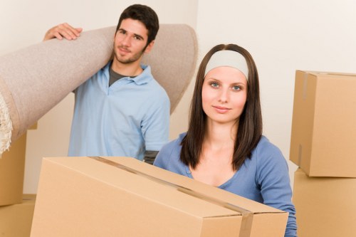 Professional movers handling stairs in a Brent flat removal